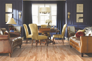Medium tone wood floor living room photo in Other with blue walls and a standard fireplace