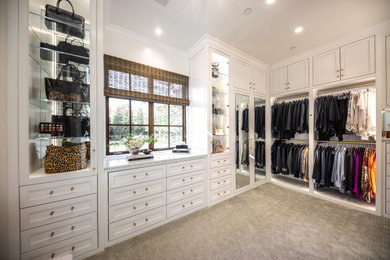 Example of a large transitional gender-neutral carpeted and gray floor walk-in closet design with beaded inset cabinets and white cabinets