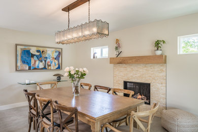 Example of a classic dining room design in Phoenix with a standard fireplace