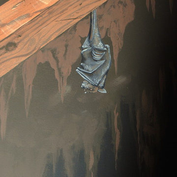 The Bat Cave Themed Mural in a stairway and lower level by Tom Taylor