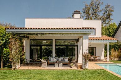 Mid-sized tuscan tile porch idea in Barcelona with a roof extension