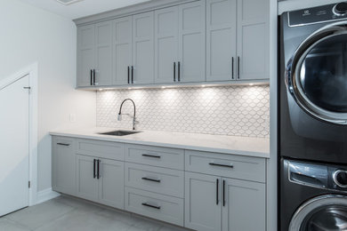 Transitional laundry room photo in Toronto