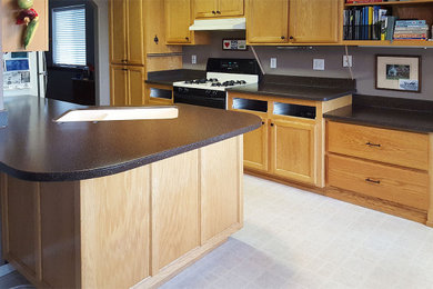 Kitchen - kitchen idea in Other with shaker cabinets, light wood cabinets, solid surface countertops, white appliances and black countertops