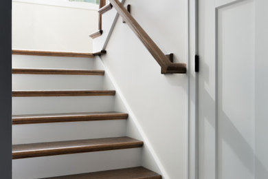 Example of a mid-sized transitional wooden u-shaped wood railing staircase design in Chicago with wooden risers