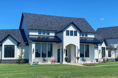 Inspiration for a large modern multicolored two-story mixed siding house exterior remodel in Oklahoma City with a mixed material roof