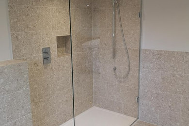 Inspiration for a large contemporary wet room bathroom in Essex with beige tiles, beige walls, beige floors and an open shower.