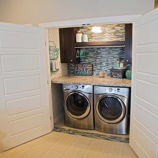 This is an example of a small classic single-wall laundry cupboard in Austin with shaker cabinets, dark wood cabinets, granite worktops, porcelain flooring, a side by side washer and dryer and grey walls.