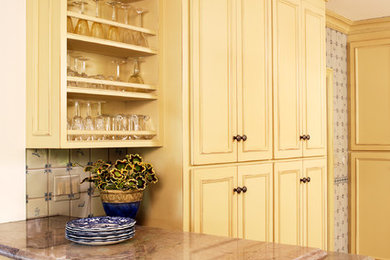 Enclosed kitchen - mid-sized traditional l-shaped marble floor enclosed kitchen idea in San Francisco with a drop-in sink, yellow cabinets, marble countertops, blue backsplash, ceramic backsplash and white appliances
