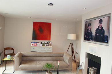 Inspiration for a contemporary living room in Surrey with a concealed tv.