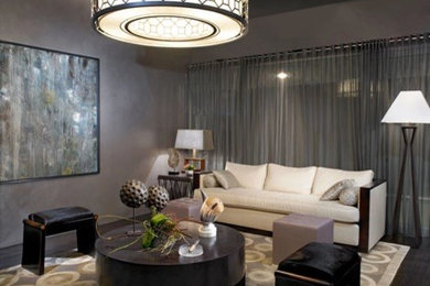 Example of a mid-sized transitional open concept dark wood floor and black floor living room design in Los Angeles with gray walls and no fireplace