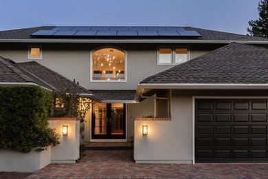Inspiration for a contemporary gray two-story stucco exterior home remodel in San Francisco with a hip roof