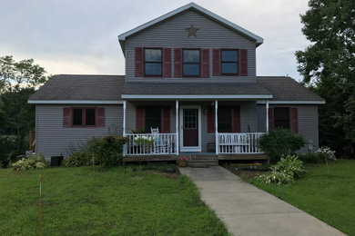 Large farmhouse gray split-level exterior home idea in New York with a shingle roof