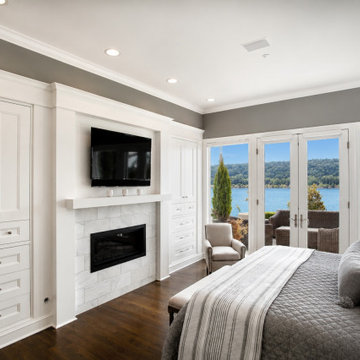 Luxury Water front Primary Bedroom with Custom Cabinetry & Fireplace