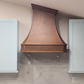 Custom Copper Range Hood as the Warm Focal Point of a Transitional Kitchen