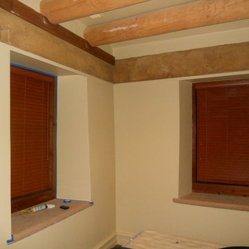 Adobe house dust control. Sheetrock level finish in bedroom.