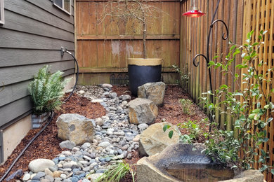 Design ideas for a mid-sized rustic partial sun backyard landscaping in Portland for summer.