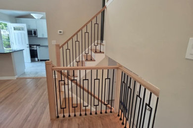 Inspiration for a mid-sized modern wooden straight mixed material railing staircase remodel in New York with wooden risers