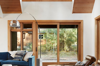 Mid-sized trendy open concept medium tone wood floor and brown floor family room photo in Sacramento with white walls, no fireplace and no tv