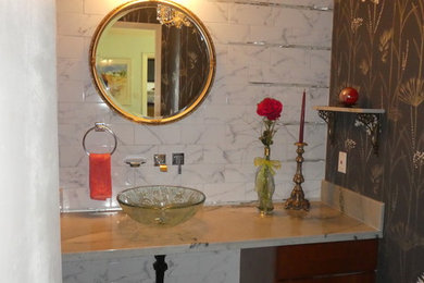 Inspiration for a mid-sized eclectic black floor powder room remodel in San Francisco with flat-panel cabinets, dark wood cabinets, multicolored walls, a vessel sink, quartzite countertops and brown countertops