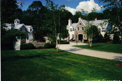 Inspiration for a large timeless beige two-story stucco exterior home remodel in Bridgeport