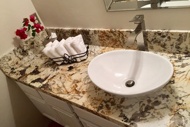 Example of a mid-sized transitional powder room design in San Diego with white cabinets, gray walls, a vessel sink and granite countertops