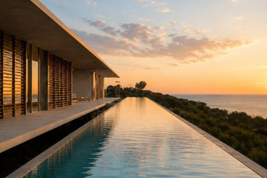 This is an example of an expansive contemporary backyard pool in Perth.
