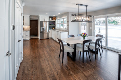 Example of a large arts and crafts dark wood floor kitchen/dining room combo design in Milwaukee with gray walls