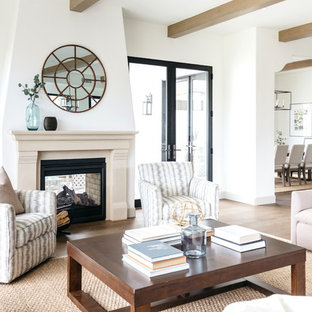 Photo of a mediterranean formal open plan living room in Los Angeles with white walls, light hardwood flooring, a two-sided fireplace and no tv.