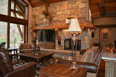 Living room - mid-sized rustic formal and open concept medium tone wood floor living room idea in Other with beige walls, a standard fireplace, a stone fireplace and a wall-mounted tv