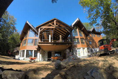Inspiration for a large timeless brown two-story wood exterior home remodel with a shingle roof