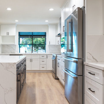 Modern White Shaker Kitchen with Navy Blue Island and Waterfall Quartz Counterto
