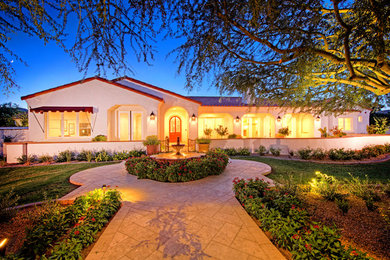 Huge mediterranean white one-story stucco exterior home idea in Phoenix with a hip roof