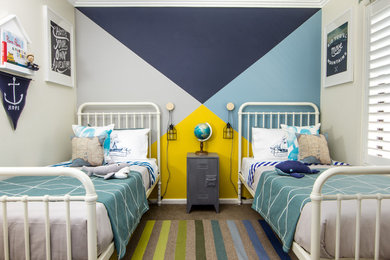 This is an example of a mid-sized beach style kids' bedroom for kids 4-10 years old and boys in Sydney with multi-coloured walls and carpet.