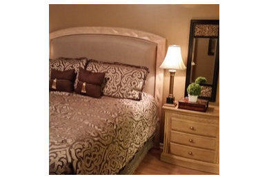 Example of a large classic master laminate floor bedroom design in Jacksonville with brown walls