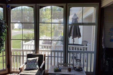This is an example of a mid-sized traditional backyard screened-in verandah in DC Metro.