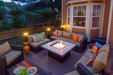 Inspiration for a large contemporary backyard deck in Boston with a fire feature and no cover.