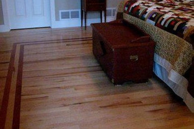 Large elegant guest light wood floor and brown floor bedroom photo in Minneapolis with beige walls and no fireplace