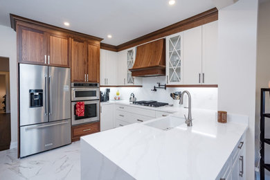 Inspiration for a mid-sized u-shaped kitchen pantry remodel in Toronto with shaker cabinets, white cabinets, quartz countertops, white backsplash, quartz backsplash, white appliances, a peninsula and white countertops