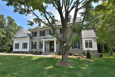 Inspiration for a large timeless multicolored three-story mixed siding exterior home remodel in DC Metro with a metal roof