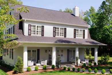 This is an example of a large traditional two-storey white house exterior in Raleigh with a hip roof and a shingle roof.