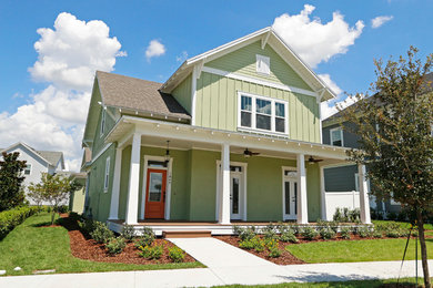 Example of a mid-sized arts and crafts green two-story wood gable roof design in Orlando