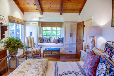 Bedroom - mid-sized rustic master medium tone wood floor and brown floor bedroom idea in San Francisco with white walls