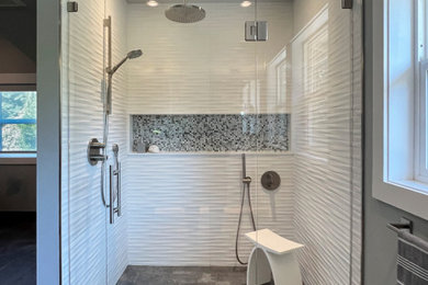 Inspiration for a large contemporary master white tile and porcelain tile porcelain tile, gray floor, double-sink and vaulted ceiling walk-in shower remodel in Seattle with flat-panel cabinets, white cabinets, a one-piece toilet, gray walls, an undermount sink, quartz countertops, a hinged shower door, white countertops, a niche and a floating vanity