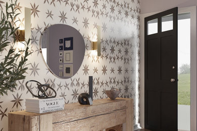 Example of a small eclectic medium tone wood floor, brown floor and wallpaper entryway design in Los Angeles with multicolored walls