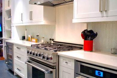Eat-in kitchen - mid-sized traditional single-wall eat-in kitchen idea in Toronto with a double-bowl sink, shaker cabinets, white cabinets, quartz countertops, white backsplash, glass tile backsplash, stainless steel appliances and an island