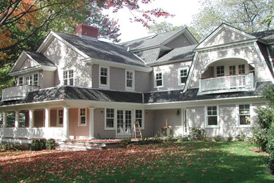 Photo of a mid-sized traditional two-storey grey house exterior in New York with wood siding, a gable roof and a shingle roof.