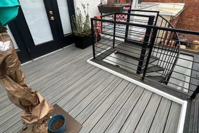 Example of a mid-sized second story metal railing deck design in DC Metro with no cover