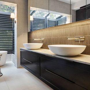 Photo of a large contemporary master bathroom in Melbourne with shaker cabinets, blue cabinets, a freestanding tub, a double shower, blue tile, ceramic tile, multi-coloured walls, ceramic floors, a vessel sink, marble benchtops, white floor, a hinged shower door, multi-coloured benchtops, a double vanity and a floating vanity.