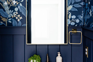 Powder room - small transitional porcelain tile powder room idea in Boston with a wall-mount sink