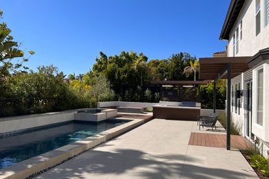Inspiration for a modern full sun backyard concrete paver landscaping in San Diego with a pergola.